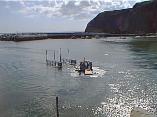 The Lifeboat Tractor and Trailer unit return to shore